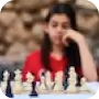 Woman sitting behind chess board